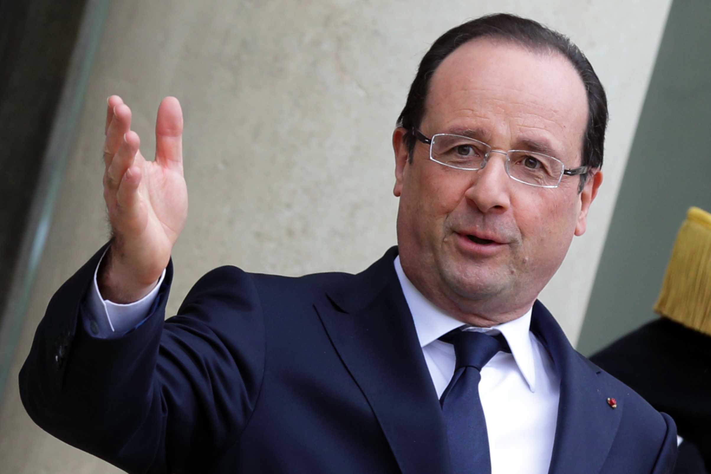 French President Francois Hollande stands on the steps of the Elysee Palace in Paris