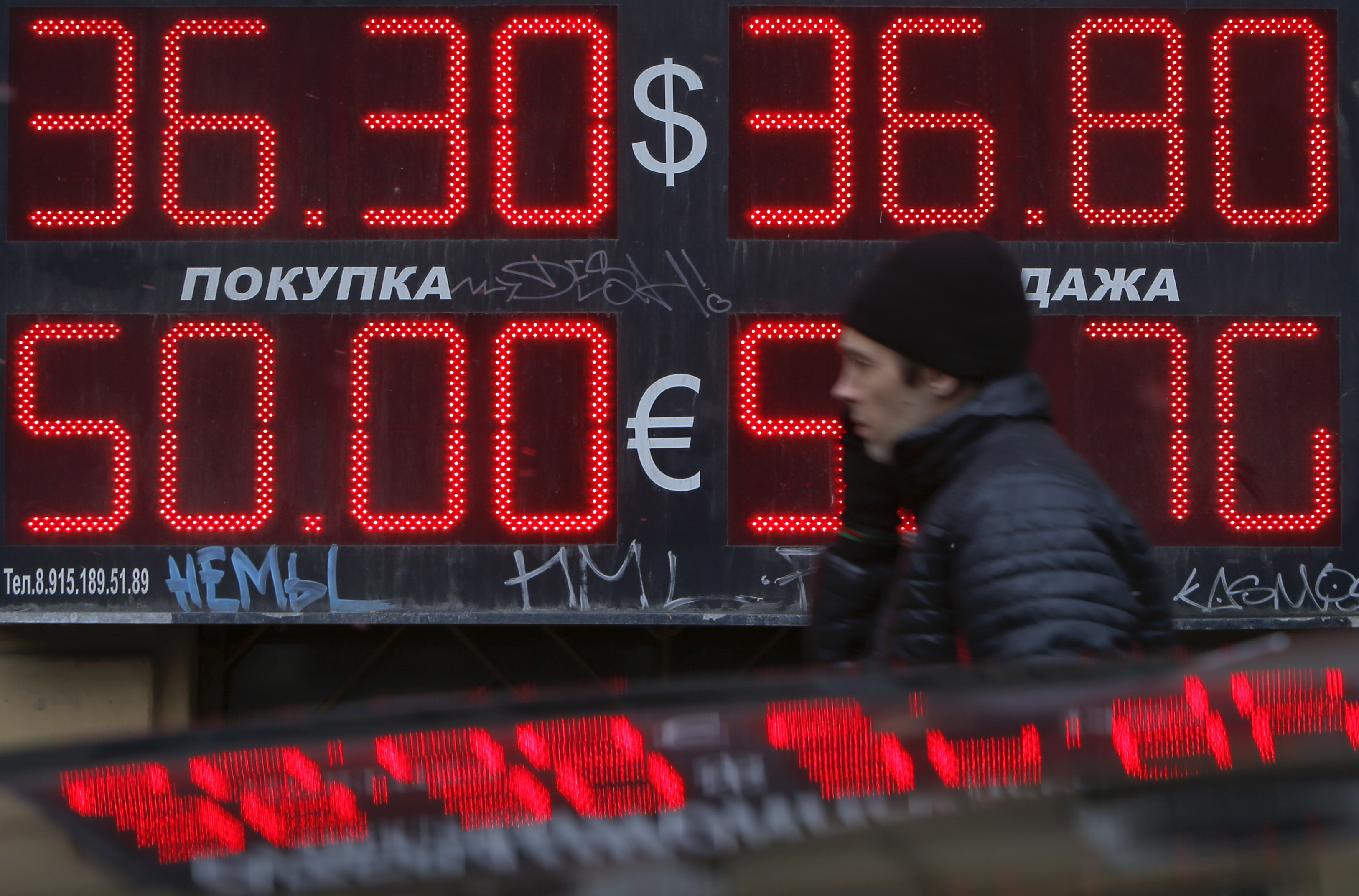 Man passes by a currency exchange office in Moscow